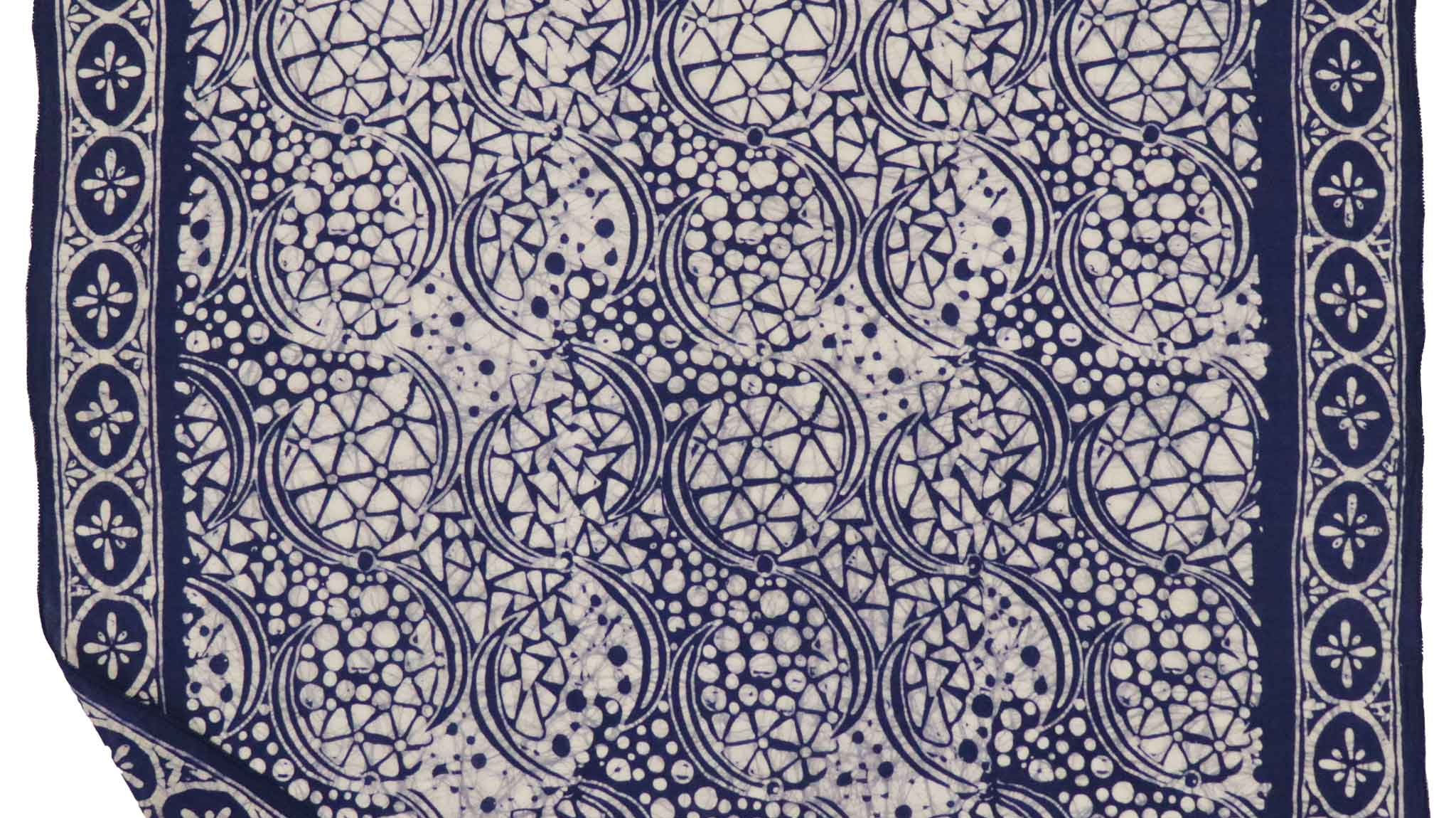 Kasih Co-op square batik bandana in Blue Stone pattern next to a long batik scarf