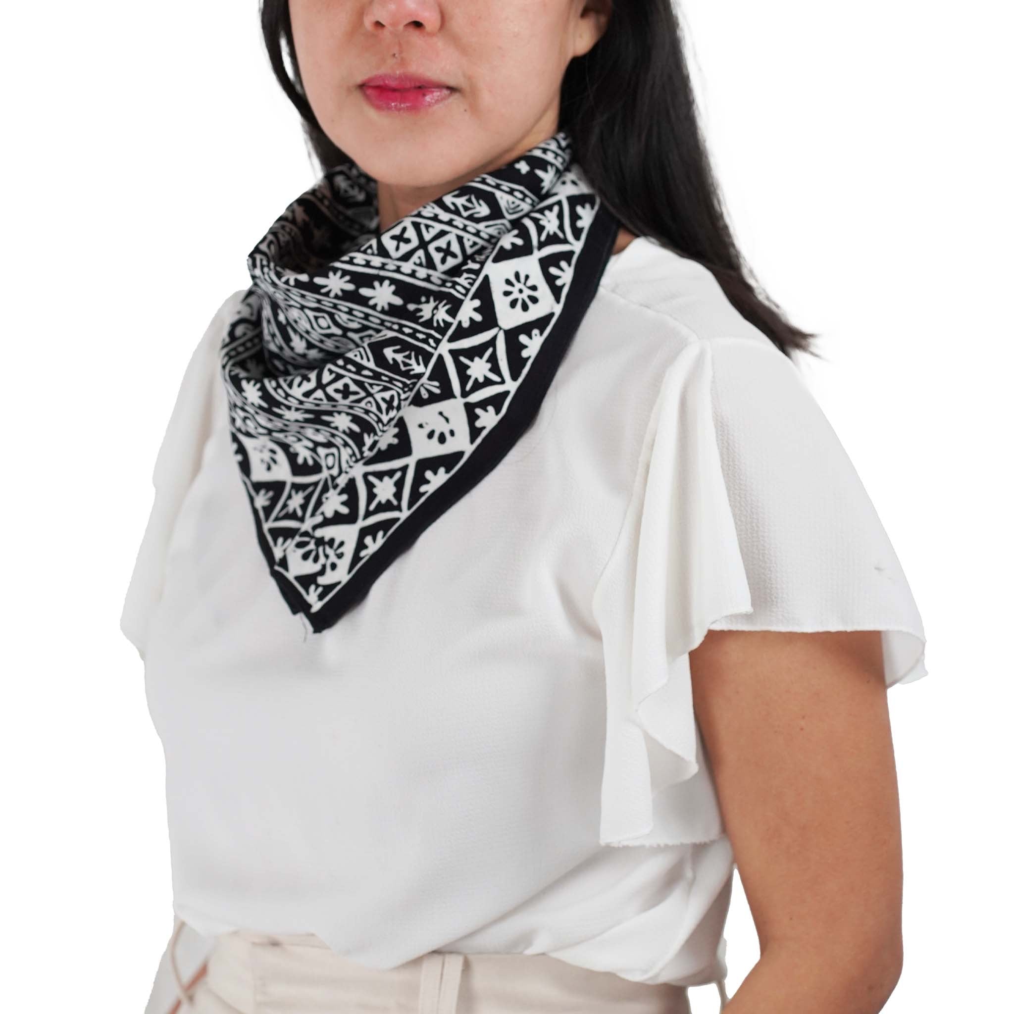 Black and white patterned 100% cotton bandana with a Kasih Co-op logo on a white background