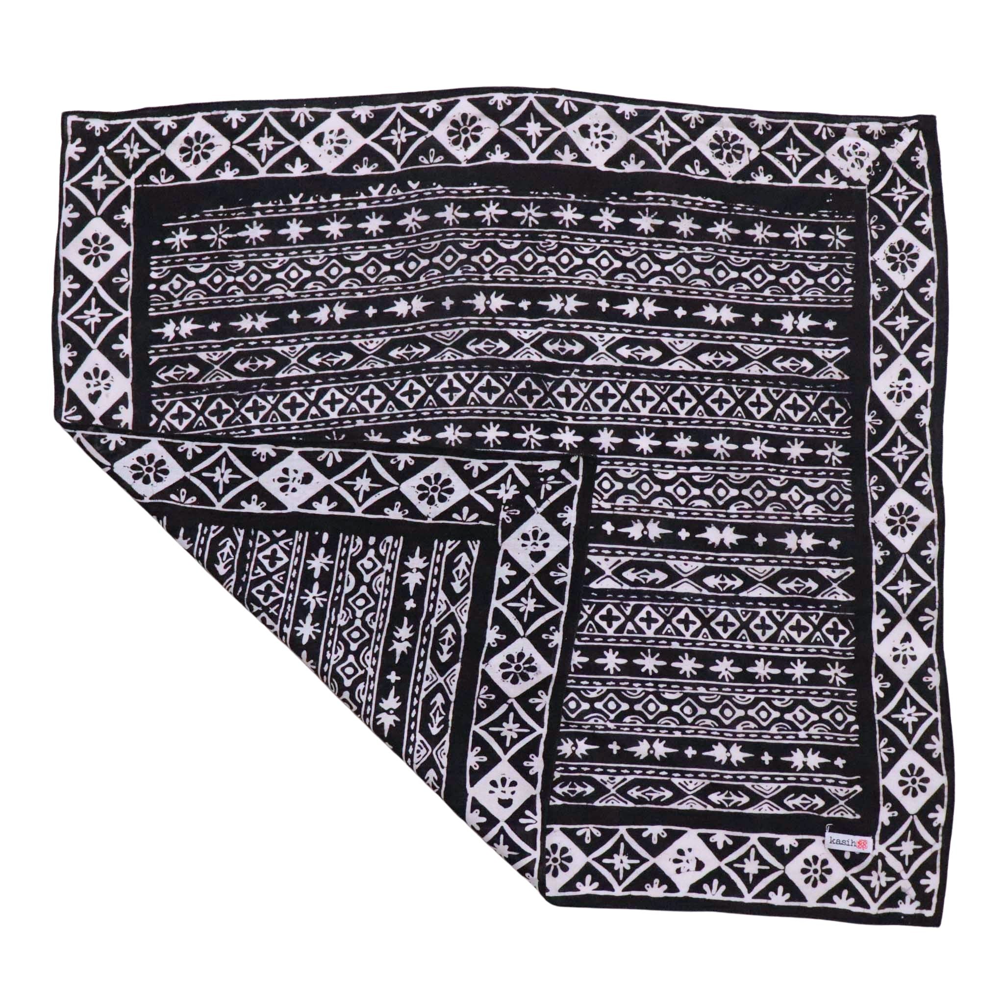 Black and white patterned 100% cotton bandana with a Kasih Co-op logo on a white background