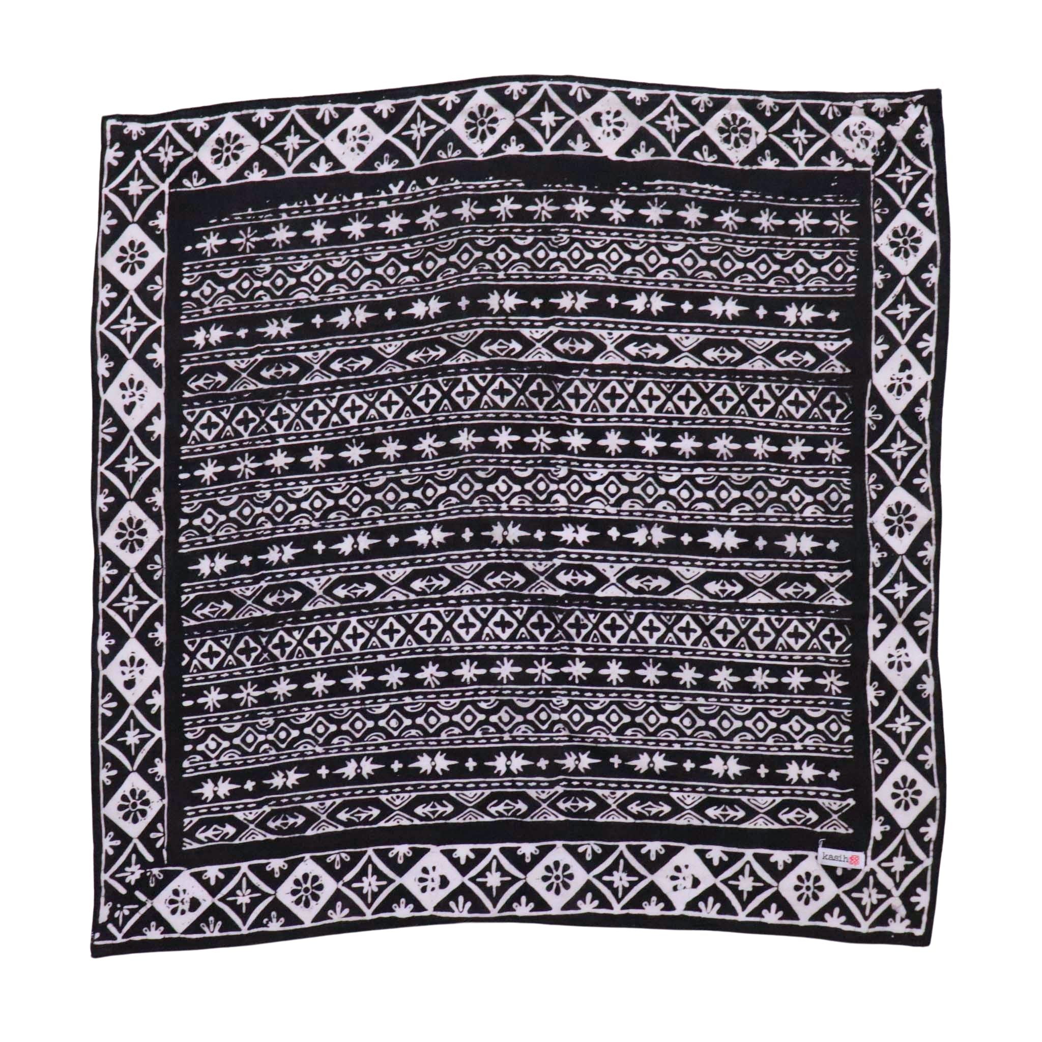 Black and white patterned bandana with a Kasih Co-op logo on a white background