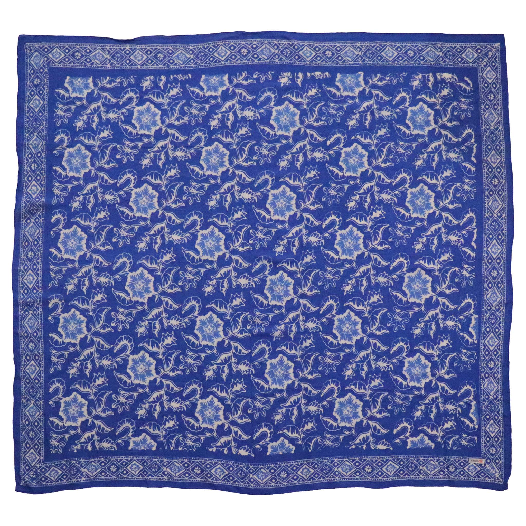 A large 39-inch hand-dyed blue batik bandana with a floral pattern laid out flat.