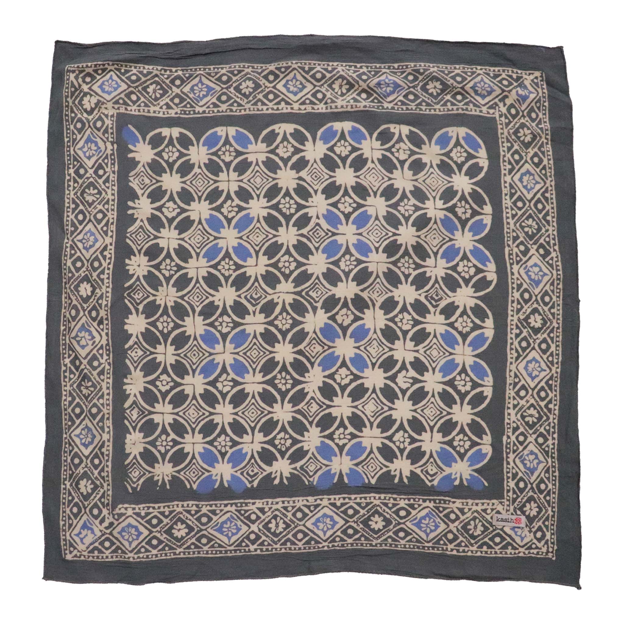 Decorative fabric batik bandana with blue and beige pattern on a white background