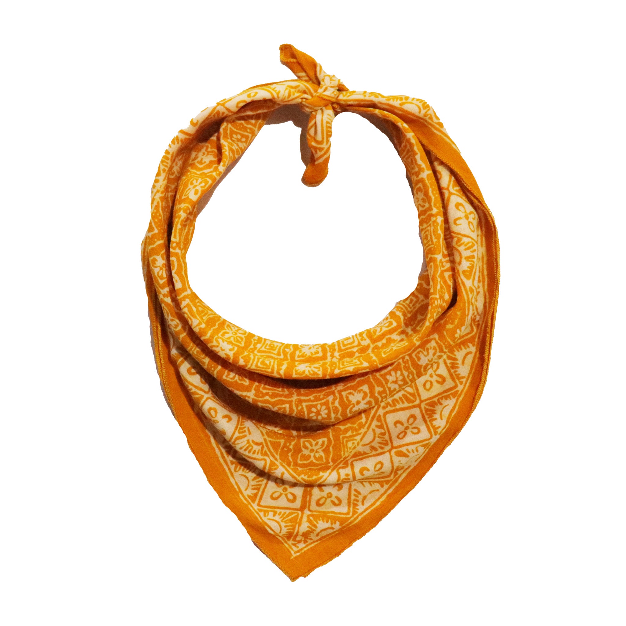 Tan cream light brown cotton batik bandana with white intricate patterns on a white background