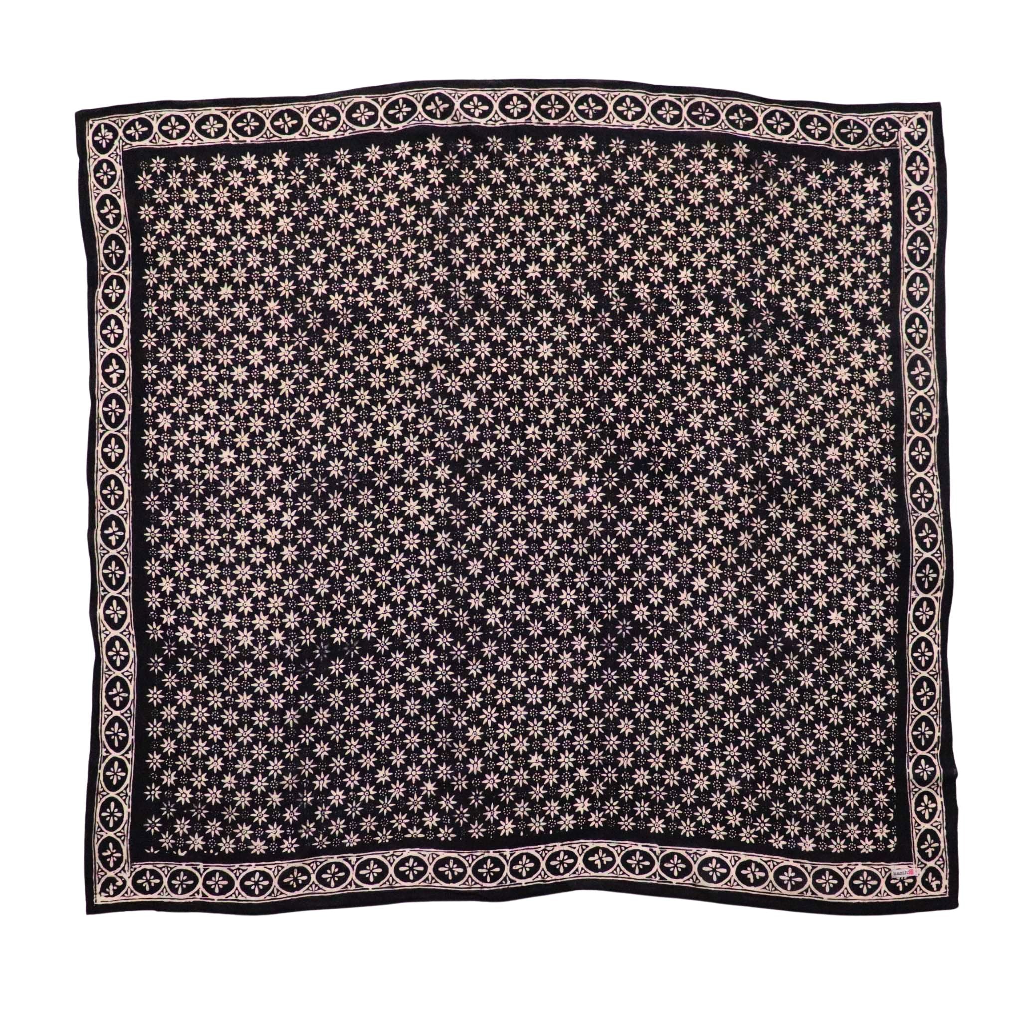 A black and gray hand-dyed batik bandana with a geometric pattern.