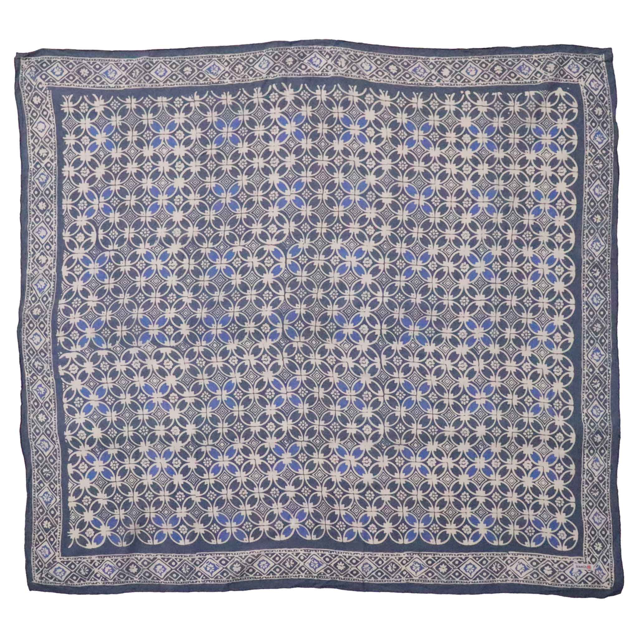 Patterned bandana square with blue and white design on a white background