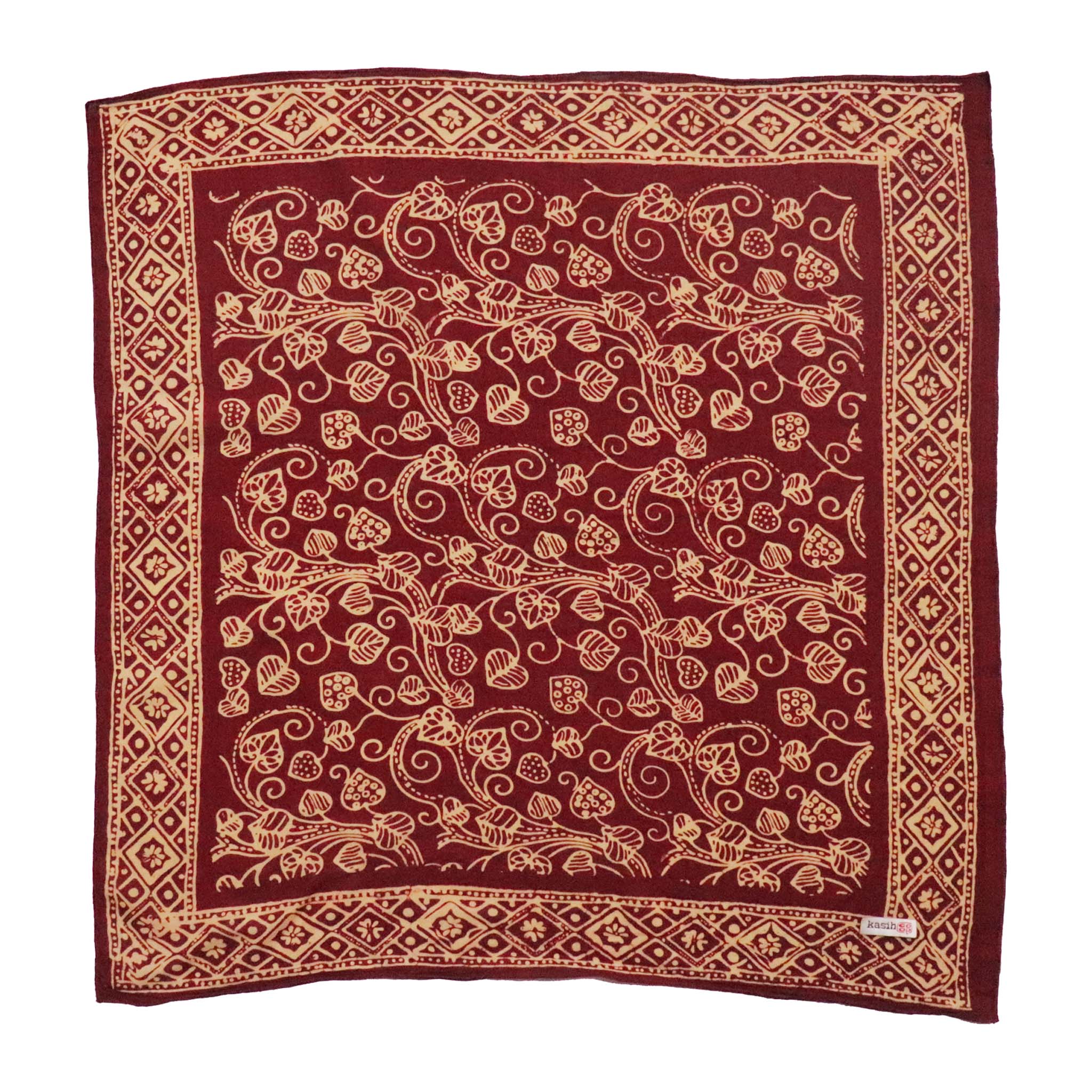 Decorative red and gold patterned bandana scarf on a white background