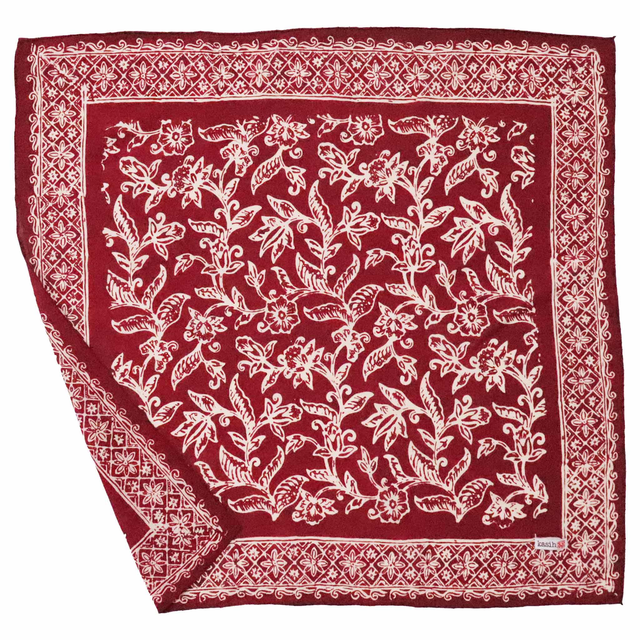 Red bandana with white floral pattern on a white background