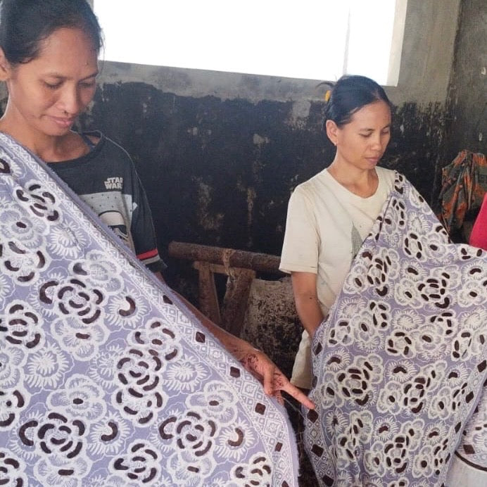 artisans women holding stamped batik bandanas
