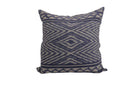 Decorative hand woven ikat pillow with blue and white pattern on a plain background