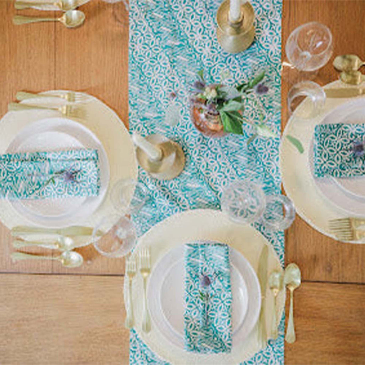 Kasih Co-op batik table runner in Green Royalty pattern styled on a dining table