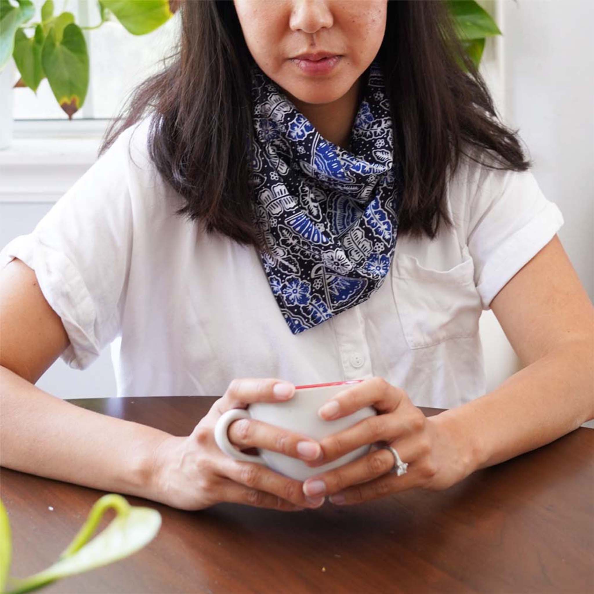 Kasih Co-op batik bandana in Black Blue Fan pattern, styled alongside other prints