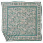 Close-up of turquoise Machete and Flower Petals batik pattern on cotton bandana