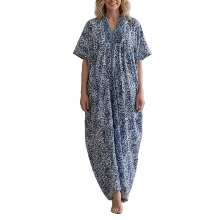Woman wearing a blue patterned dress standing